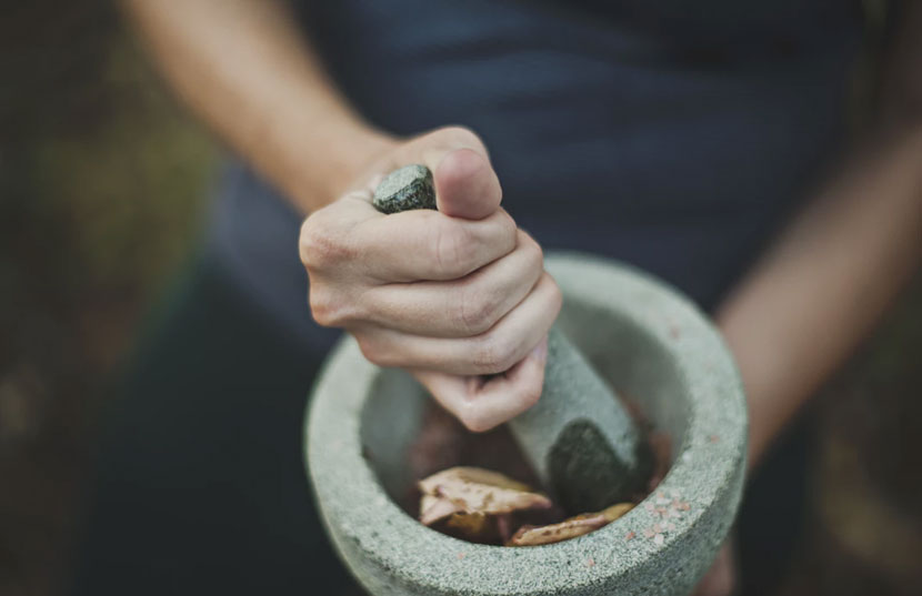 Person using mortar and pestle