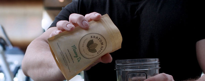 A man pouring Kratom into the mouth of a jar