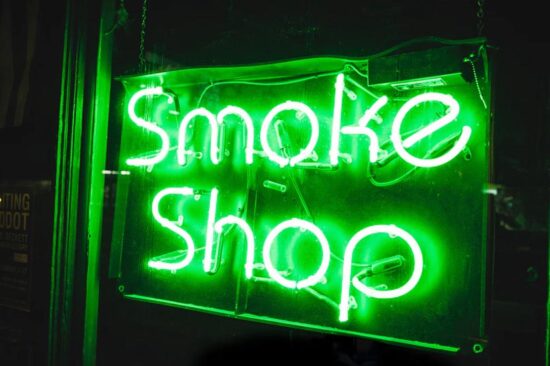 A green neon smoke shop sign