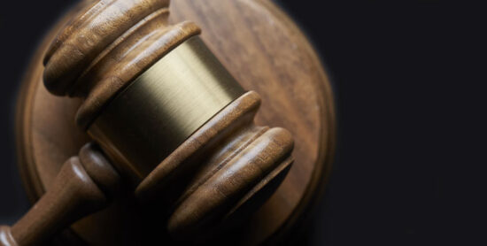 A brass-bound gavel on a soundblock