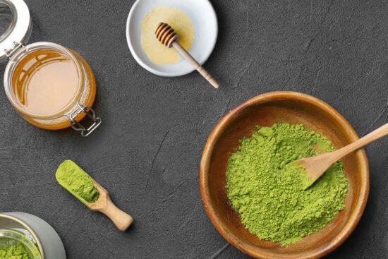 The ingredients for delicious kratom honey balls laid out on a gray surface