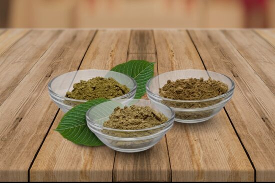 Three bowls of kratom sit on a slatted wooden surface