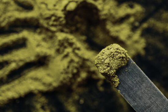 A user measures out a microdose of kratom