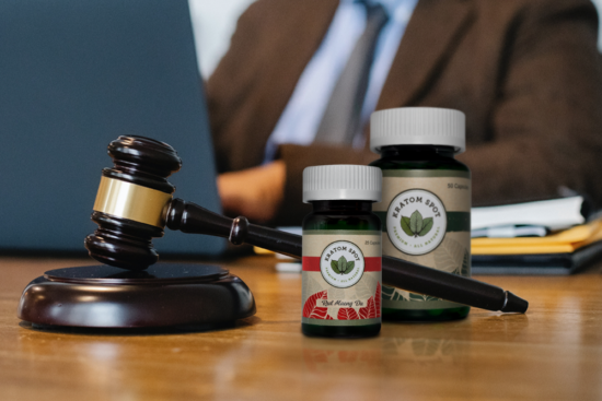 A gavel next to kratom products