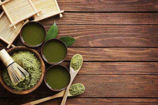Someone who learned how to buy kratom online set up powder and tea on their desk